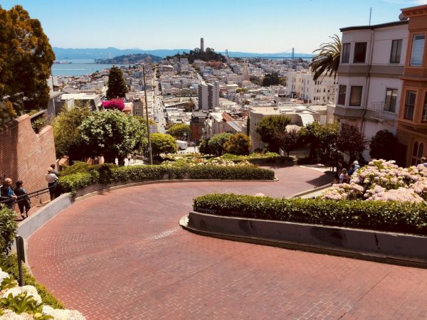 Lombard Street's crooked brick curves with Coit Tower view, San Francisco