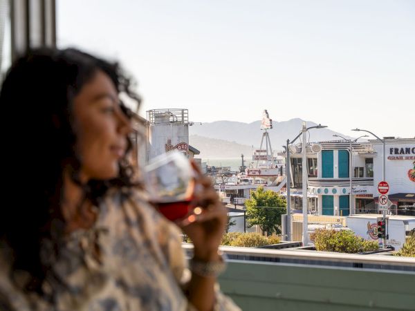 Guest enjoying a glass of wine on a sunny San Francisco waterfront terrace