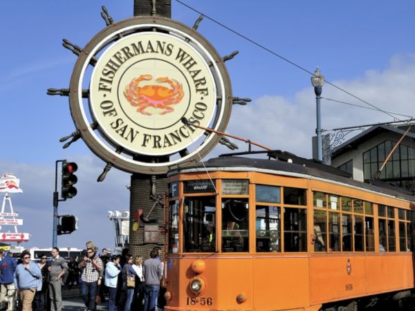 Fisherman&rsquo;s Wharf crab sign and historic streetcar in San Francisco