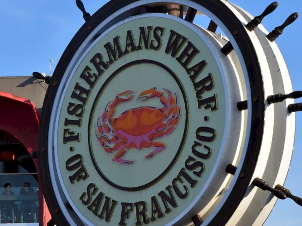 Fisherman&rsquo;s Wharf crab wheel sign under a blue San Francisco sky